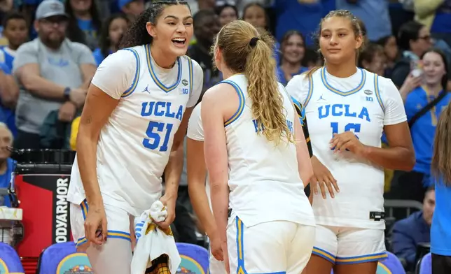 UCLA center Lauren Betts (51) celebrates with teammates during the second half of the women's National Championship Final Four NCAA college basketball tournament game against South Carolina, Sunday, April 5, 2026, in Phoenix. (AP Photo/Rick Scuteri)