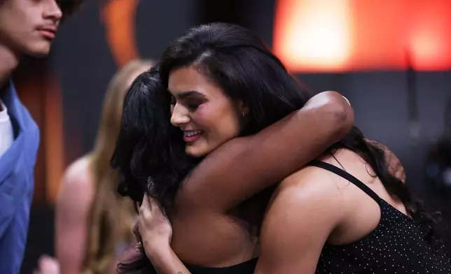 UCLA center Lauren Betts hugs her mother Michelle after being selected fourth overall by the Washington Mystics in the first round of the WNBA basketball draft Monday, April 13, 2026, in New York. (AP Photo/Pamela Smith)