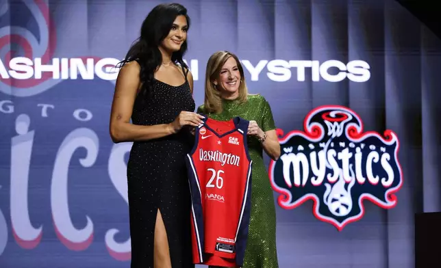 UCLA center Lauren Betts poses with WNBA commissioner Cathy Engelbert after being selected fourth overall by the Washington Mystics in the first round of the WNBA basketball draft Monday, April 13, 2026, in New York. (AP Photo/Pamela Smith)