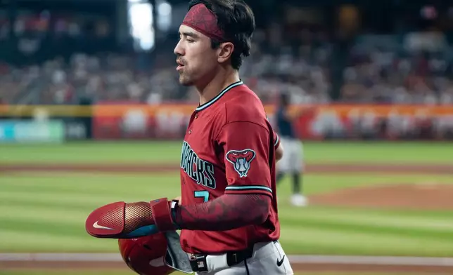Arizona Diamondbacks' Corbin Carroll (7) jogs back to the dugout after scoring during the fourth inning of a baseball game against the Atlanta Braves, Sunday, April 5, 2026, in Phoenix. (AP Photo/Rebecca Noble)