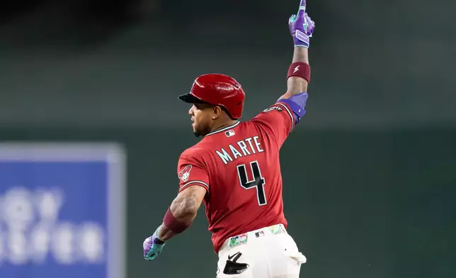 Arizona Diamondbacks' Ketel Marte (4) gestures after hitting the game-winning home run in the 10th inning of a baseball game against the Atlanta Braves, Sunday, April 5, 2026, in Phoenix. (AP Photo/Rebecca Noble)