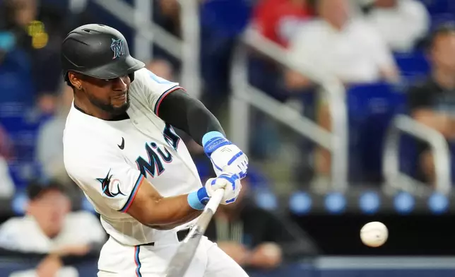 Miami Marlins Otto Lopez hits a home run during the eighth inning of a baseball game against the Chicago White Sox, Wednesday, April 1, 2026, in Miami. (AP Photo/Rebecca Blackwell)