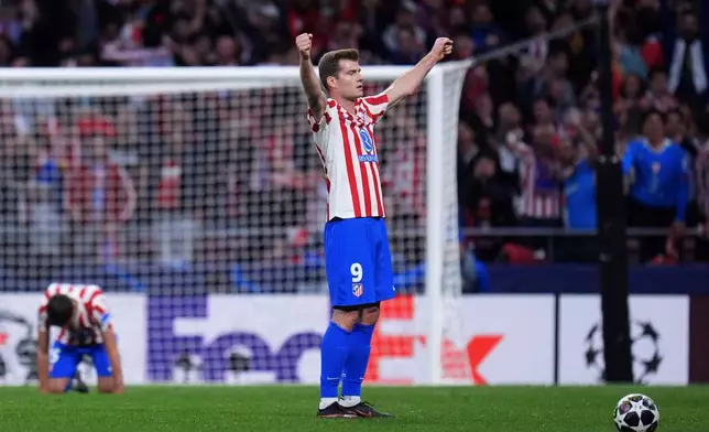 Atletico Madrid's Alexander Sorloth celebrates at the end of the Champions League quarterfinal second leg soccer match between Atletico Madrid and Barcelona in Madrid, Spain, Tuesday, April 14, 2026. (AP Photo/Manu Fernandez)