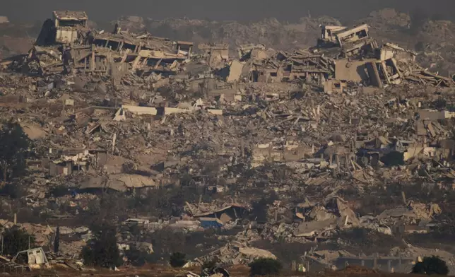 FILE - Buildings that were destroyed during the Israeli ground and air operations stand in northern of Gaza Strip as seen from southern Israel, Thursday, July 10, 2025. (AP Photo/Leo Correa, File)