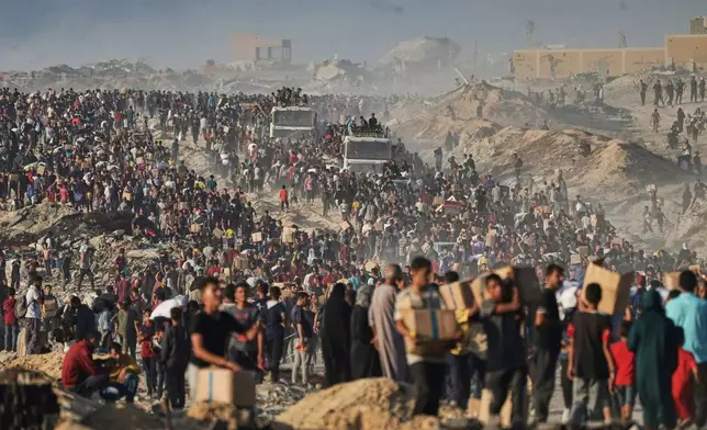 FILE - Palestinians carry sacks and boxes of food and humanitarian aid that was unloaded from a World Food Program convoy that had been heading to Gaza City in the northern Gaza Strip, Monday, June 16, 2025. (AP Photo/Jehad Alshrafi, File)
