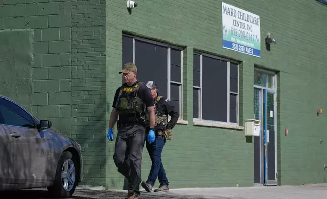 FBI agents walk outside the Mini Child Care Center (formerly Mako Childcare) in Minneapolis, Minn. on Tuesday, April 28, 2026. (Anthony Soufflé/Minnesota Star Tribune via AP) CORRECTION: Mini Child Care, not Mako Child Care