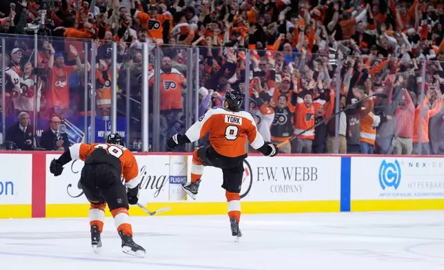 Philadelphia Flyers' Cam York (8) celebrates after scoring the game-winning goal during overtime in Game 6 against the Pittsburgh Penguins in the first round of the NHL hockey Stanley Cup playoffs series Wednesday, April 29, 2026, in Philadelphia. (AP Photo/Matt Slocum)