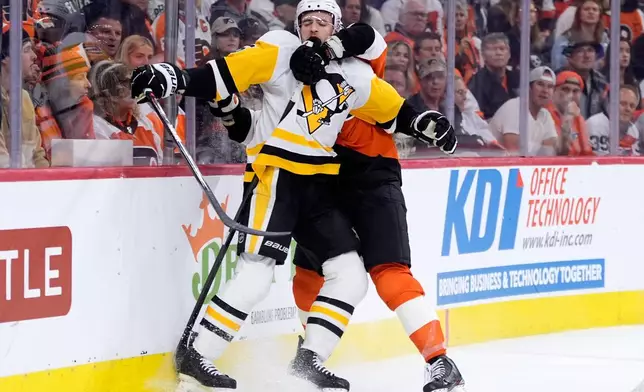 Pittsburgh Penguins' Ryan Shea, left, is grabbed by Philadelphia Flyers' Luke Glendening during the second period of Game 6 in the first round of the NHL hockey Stanley Cup playoffs series Wednesday, April 29, 2026, in Philadelphia. (AP Photo/Matt Slocum)