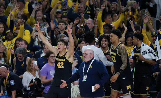 Michigan forward Will Tschetter (42) celebrates after an NCAA college basketball tournament semifinal game against Arizona at the Final Four, Saturday, April 4, 2026, in Indianapolis. (AP Photo/AJ Mast)