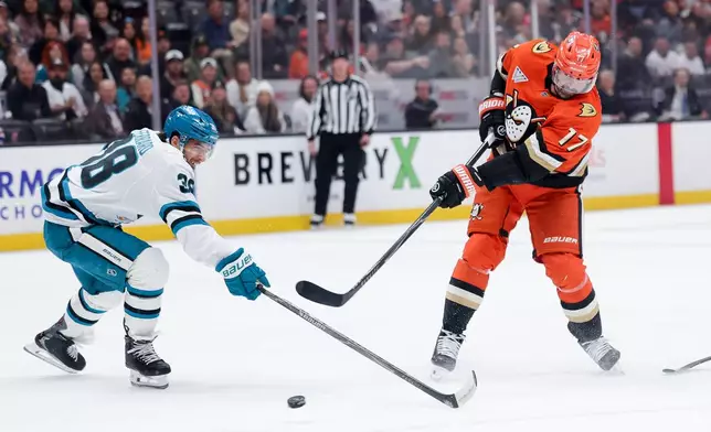 Anaheim Ducks left wing Alex Killorn, right, shoots against San Jose Sharks defenseman Mario Ferraro, left, during the first period of an NHL hockey game Thursday, April 9, 2026, in Anaheim, Calif. (AP Photo/Ryan Sun)
