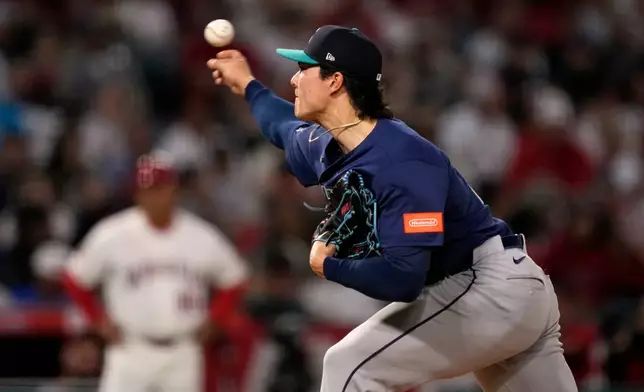 Seattle Mariners starting pitcher Bryan Woo throws to the plate during the second inning of an opening-day baseball game against the Los Angeles Angels, Friday, April 3, 2026, in Anaheim, Calif. (AP Photo/Mark J. Terrill)