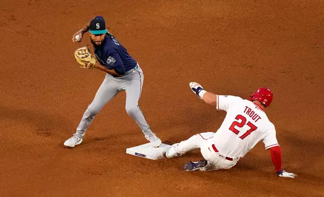 Los Angeles Angels' Mike Trout, right, is forced out at second by Seattle Mariners shortstop J.P. Crawford after Nolan Schanuel grounded into a fielder's choice during the first inning of an opening-day baseball game Friday, April 3, 2026, in Anaheim, Calif. (AP Photo/Mark J. Terrill)