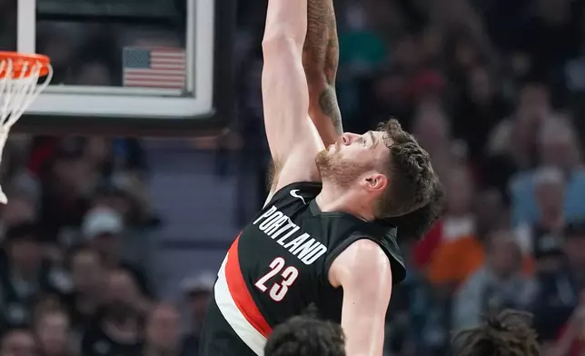 Portland Trail Blazers center Donovan Clingan goes for a jump ball during the first half in Game 4 of a first-round NBA basketball playoffs series against the San Antonio Spurs, in Portland, Ore., Sunday, April 26, 2026. (AP Photo/Jenny Kane)