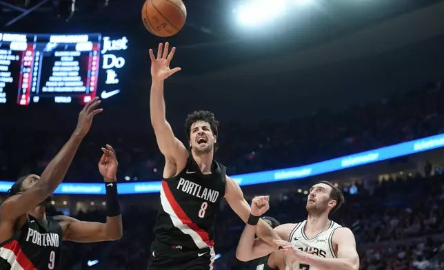 Portland Trail Blazers forward Deni Avdija (8) goes for the ball as San Antonio Spurs center/forward Luke Kornet (7) looks on during the first half in Game 4 of a first-round NBA basketball playoffs series in Portland, Ore., Sunday, April 26, 2026. (AP Photo/Jenny Kane)