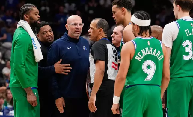 Dallas Mavericks head coach Jason Kidd, center, left, talks to Eric Lewis (42) after Kidd was ejected in the second half of an NBA basketball game against the Orlando Magic Friday, April 3, 2026, in Dallas. (AP Photo/Tony Gutierrez)