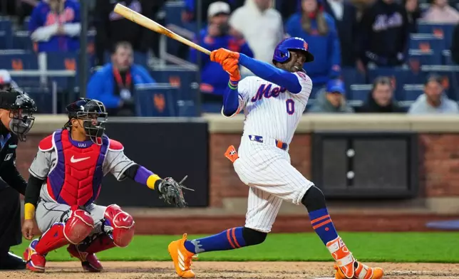 New York Mets' Ronny Mauricio (0) hits a walk-off single during the tenth inning of a baseball game against the Arizona Diamondbacks Tuesday, April 7, 2026, in New York. (AP Photo/Frank Franklin II)