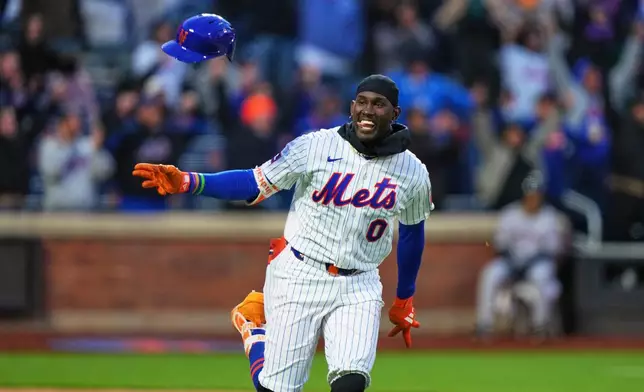 New York Mets' Ronny Mauricio (0) celebrates after hitting a game winning walk-off single during the tenth inning of a baseball game against the Arizona Diamondbacks Tuesday, April 7, 2026, in New York. (AP Photo/Frank Franklin II)