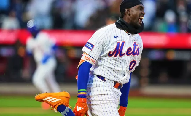 New York Mets' Ronny Mauricio (0) celebrates after hitting a walk-off single during the tenth inning of a baseball game Tuesday, April 7, 2026, in New York. (AP Photo/Frank Franklin II)