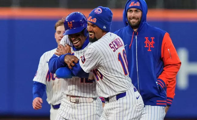New York Mets' Francisco Lindor (12) celebrates with teammate Marcus Semien (10) after a baseball game against the Arizona Diamondbacks Tuesday, April 7, 2026, in New York. (AP Photo/Frank Franklin II)