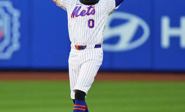 New York Mets' Ronny Mauricio (0) celebrates after hitting a game winning walk-off single during the tenth inning of a baseball game against the Arizona Diamondbacks Tuesday, April 7, 2026, in New York. (AP Photo/Frank Franklin II)