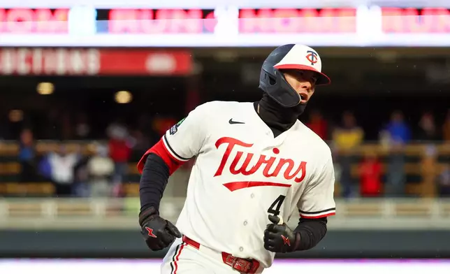 Minnesota Twins' Tristan Gray rounds the bases after hitting a grand slam during the seventh inning of a baseball game against the Tampa Bay Rays, Friday, April 3, 2026, in Minneapolis. (AP Photo/Ellen Schmidt)