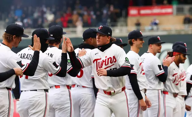 Minnesota Twins' Luke Keaschall, center, is announced in his team's starting lineup before a baseball game against the Tampa Bay Rays, Friday, April 3, 2026, in Minneapolis. (AP Photo/Ellen Schmidt)