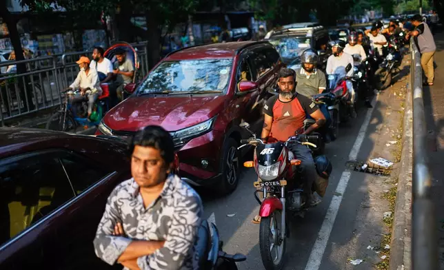 Motorists queue up outside a fuel pump in Dhaka, as Bangladesh tries to handle its energy crisis related to the Iran war, Sunday, April 5, 2026. (AP Photo/Mahmud Hossain Opu)