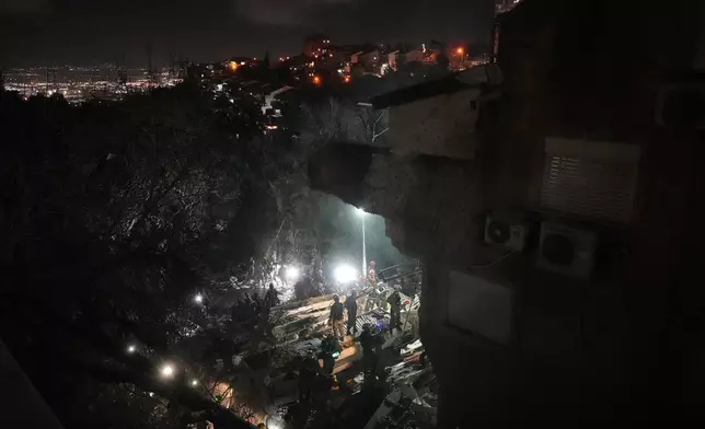 Israeli security forces and rescue teams work amid the rubble of a residential building struck by an Iranian missile in Haifa, Israel, Sunday, April 5, 2026. (AP Photo/Ariel Schalit)