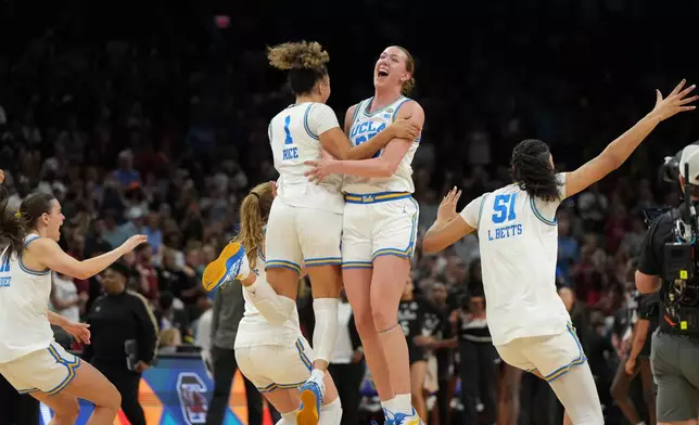 UCLA guard Kiki Rice (1) and UCLA forward Amanda Muse (33) celebrate after defeating South Carolina in the women's National Championship Final Four NCAA college basketball tournament game, Sunday, April 5, 2026, in Phoenix. (AP Photo/Rick Scuteri)