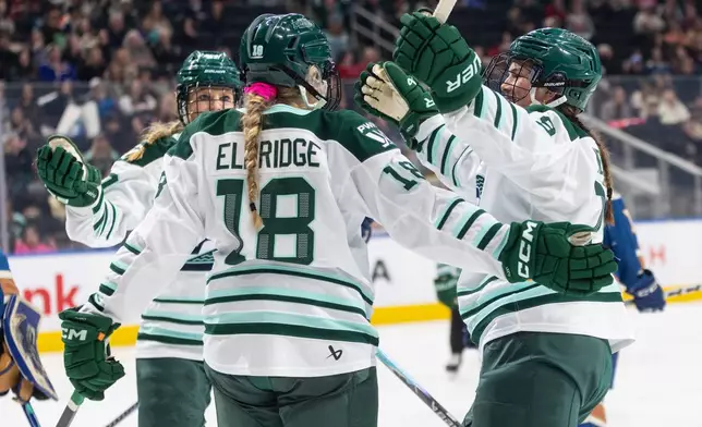 Boston Fleet's Shay Maloney (left), Jessie Eldridge (18) and Sophie Shirley (9) celebrate a goal against the Vancouver Goldeneyes during second period PWHL hockey action in Edmonton on Tuesday, April 7, 2026. (Jason Franson/The Canadian Press via AP)
