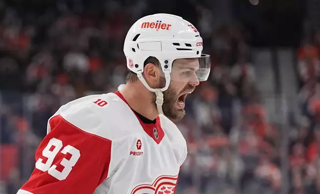 Detroit Red Wings' Alex DeBrincat reacts after scoring past Philadelphia Flyers goaltender Samuel Ersson during the first period of an NHL hockey game, Thursday, April 2, 2026, in Philadelphia. (AP Photo/Matt Rourke)