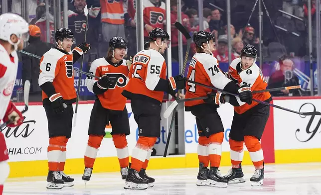 Philadelphia Flyers' Tyson Foerster, right, celebrates a goal past Detroit Red Wings goaltender John Gibson with teammates, from left, Travis Sanheim, Trevor Zegras, Rasmus Ristolainen, Owen Tippett during the second period of an NHL hockey game, Thursday, April 2, 2026, in Philadelphia. (AP Photo/Matt Rourke)