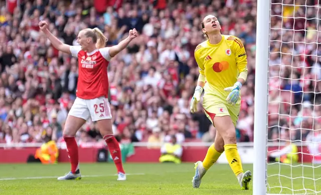 OL Lyonnes' goalkeeper Christiane Endler, right, reacts as Arsenal's Stina Blackstenius, left, celebrates her side's first goal during the Women's Champions League semi-final, first leg soccer match between Arsenal and OL Lyonnes in London, England, Sunday April 26, 2026. (Andrew Matthews/PA via AP)