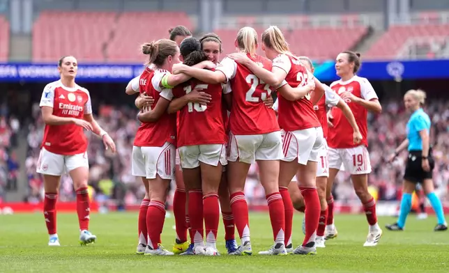 Arsenal's players celebrate their side's second goal scored by Olivia Smith during the Women's Champions League semi-final, first leg soccer match between Arsenal and OL Lyonnes in London, England, Sunday, April 26, 2026. (Andrew Matthews/PA via AP)