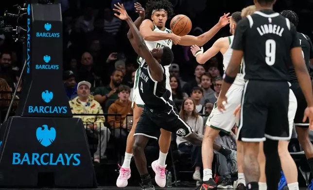 Milwaukee Bucks center Jericho Sims (00) blocks Brooklyn Nets guard Drake Powell (4) during the first half of an NBA basketball game, Tuesday, April 7, 2026, in New York. (AP Photo/Yuki Iwamura)