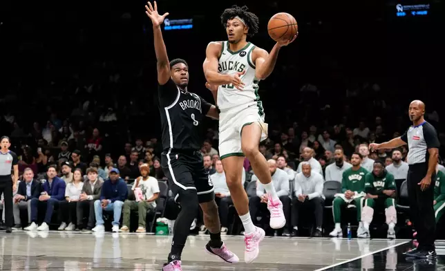 Milwaukee Bucks center Jericho Sims (00) passes the ball during the first half of an NBA basketball game against Brooklyn Nets, Tuesday, April 7, 2026, in New York. (AP Photo/Yuki Iwamura)