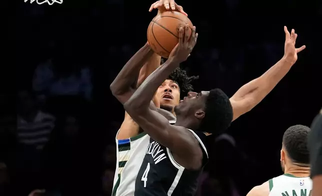 Milwaukee Bucks center Jericho Sims (00) blocks Brooklyn Nets guard Drake Powell (4) during the first half of an NBA basketball game, Tuesday, April 7, 2026, in New York. (AP Photo/Yuki Iwamura)