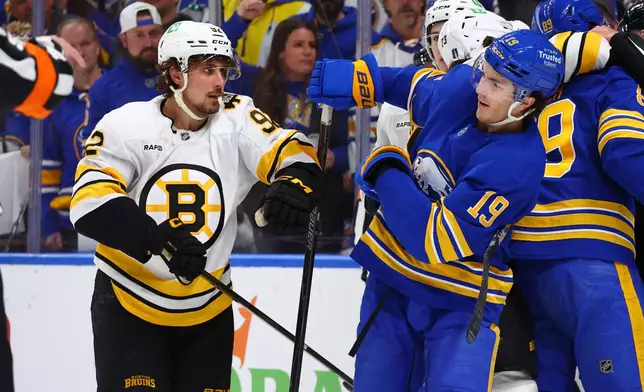 Boston Bruins center Marat Khusnutdinov (92) and Buffalo Sabres center Peyton Krebs (19) battle after a whistle during the first period in Game 1 of a first-round NHL hockey Stanley Cup playoff series Sunday, April 19, 2026, in Buffalo, N.Y. (AP Photo/Jeffrey T. Barnes)