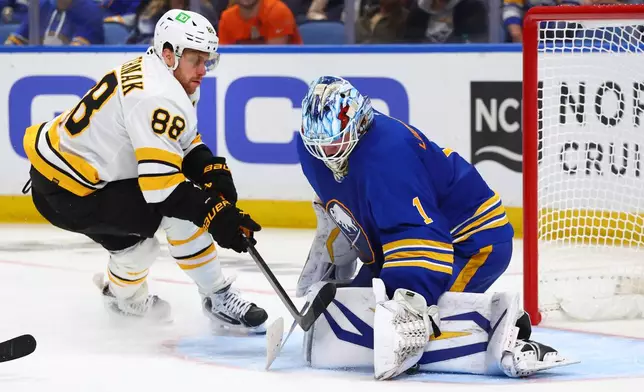 Buffalo Sabres goaltender Ukko-Pekka Luukkonen (1) stops Boston Bruins right wing David Pastrnak (88) during the second period in Game 1 of a first-round NHL hockey Stanley Cup playoff series Sunday, April 19, 2026, in Buffalo, N.Y. (AP Photo/Jeffrey T. Barnes)