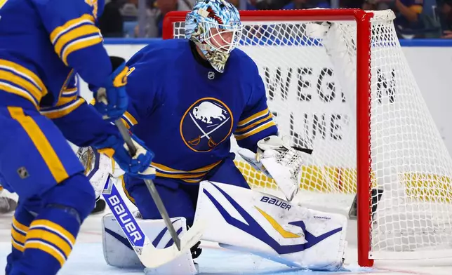 Buffalo Sabres goaltender Ukko-Pekka Luukkonen, right, watches the puck go wide during the second period in Game 1 against the Boston Bruins in a first-round NHL hockey Stanley Cup playoff series Sunday, April 19, 2026, in Buffalo, N.Y. (AP Photo/Jeffrey T. Barnes)