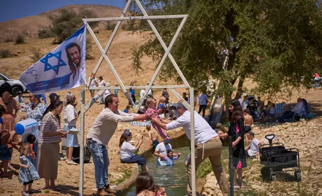 Israeli settlers and others enjoy a day at a spring in the Jordan Valley during Israel's Independence Day, in Auja, in the occupied West Bank, Wednesday, April 22, 2026. (AP Photo/Ohad Zwigenberg)