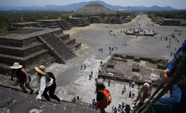 Tourists visit the Teotihuacan pyramids after the archaeological site reopened two days after a gunman opened fire, killing a Canadian tourist, outside Mexico City, Wednesday, April 22, 2026. (AP Photo/Eduardo Verdugo)