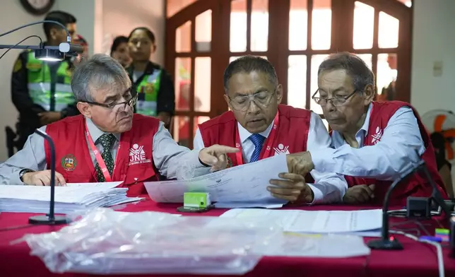Special Electoral Jury appointees recount votes for the 2026 general election, in Lima, Peru, Wednesday, April 22, 2026. (AP Photo/Guadalupe Pardo)