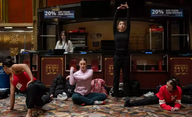 Dancers warm up and stretch before an audition for the Radio City Rockettes at Radio City Music Hall in New York, on Wednesday, April 22, 2026. (AP Photo/Yuki Iwamura)