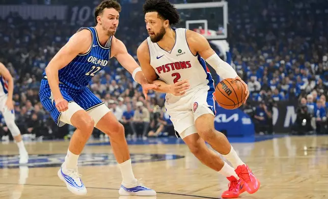 Detroit Pistons guard Cade Cunningham (2) drives around Orlando Magic forward Franz Wagner (22) during the first half in Game 4 of a first-round NBA basketball playoff series, Monday, April 27, 2026, in Orlando, Fla. (AP Photo/John Raoux)