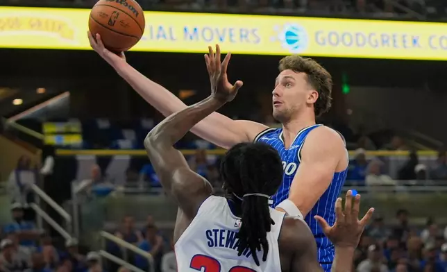 Orlando Magic forward Franz Wagner, right, shoots over Detroit Pistons forward Isaiah Stewart during the second half in Game 4 of a first-round NBA basketball playoff series, Monday, April 27, 2026, in Orlando, Fla. (AP Photo/John Raoux)