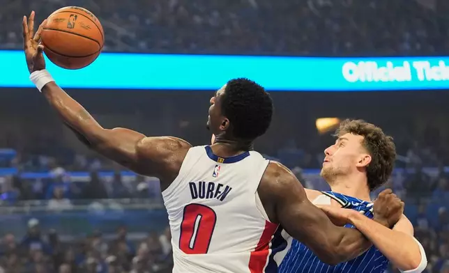Detroit Pistons center Jalen Duren (0) grabs a rebound against Orlando Magic forward Franz Wagner, right, during the first half in Game 4 of a first-round NBA basketball playoff series, Monday, April 27, 2026, in Orlando, Fla. (AP Photo/John Raoux)