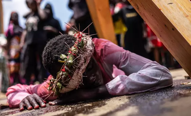 FILE - Christians take part in a Way of the Cross re-enactment of the crucifixion of Jesus Christ on Good Friday during Holy Week in Kibera informal settlement in Nairobi, Kenya, Friday, April 3, 2026. (AP Photo/Samson Otieno, File)