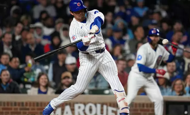 Chicago Cubs' Seiya Suzuki (27) hits a two-run home run during the fifth inning of a baseball game against the Philadelphia Phillies, Wednesday, April 22, 2026, in Chicago. (AP Photo/Erin Hooley)