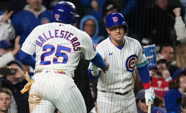 Chicago Cubs designated hitter Moisés Ballesteros (25) celebrates with Alex Bregman (3) after scoring on a single from Pete Crow-Armstrong (4) during the eighth inning of a baseball game against the Philadelphia Phillies, Wednesday, April 22, 2026, in Chicago. (AP Photo/Erin Hooley)